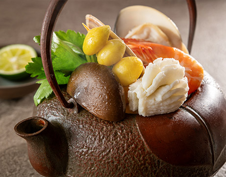 Earthenware pot with conger eel, shrimp, clams, mushrooms, ginkgo nuts, and mitsuba